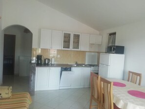 A compact kitchen with white cabinets, a microwave, and a coffee maker. - Apartment in Kanica with Seaview, Terrace, Air condition, WIFI (5168-3) (Rogoznica)