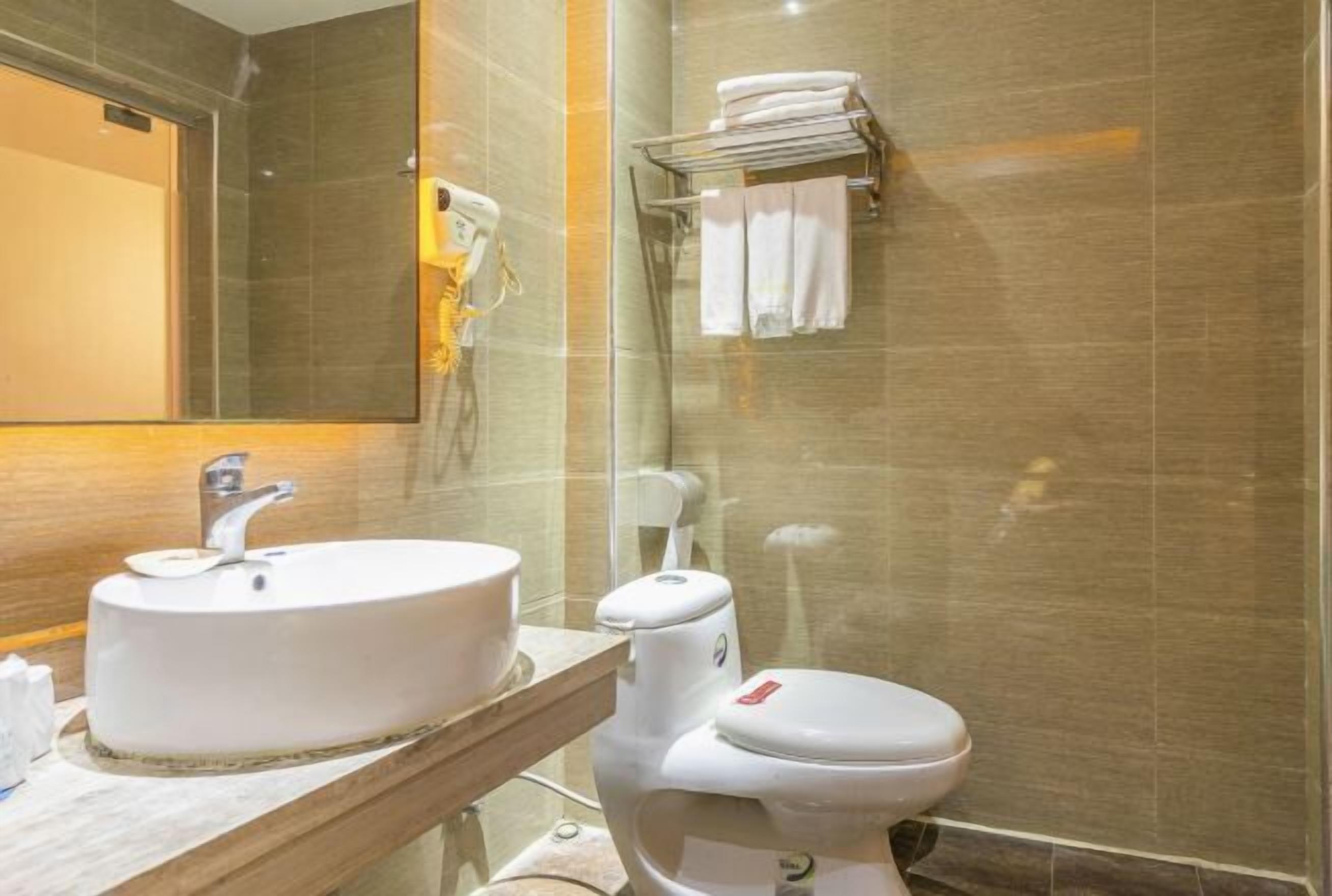 Ein Badezimmer mit Waschbecken, Toilette und Handtuchhalter.