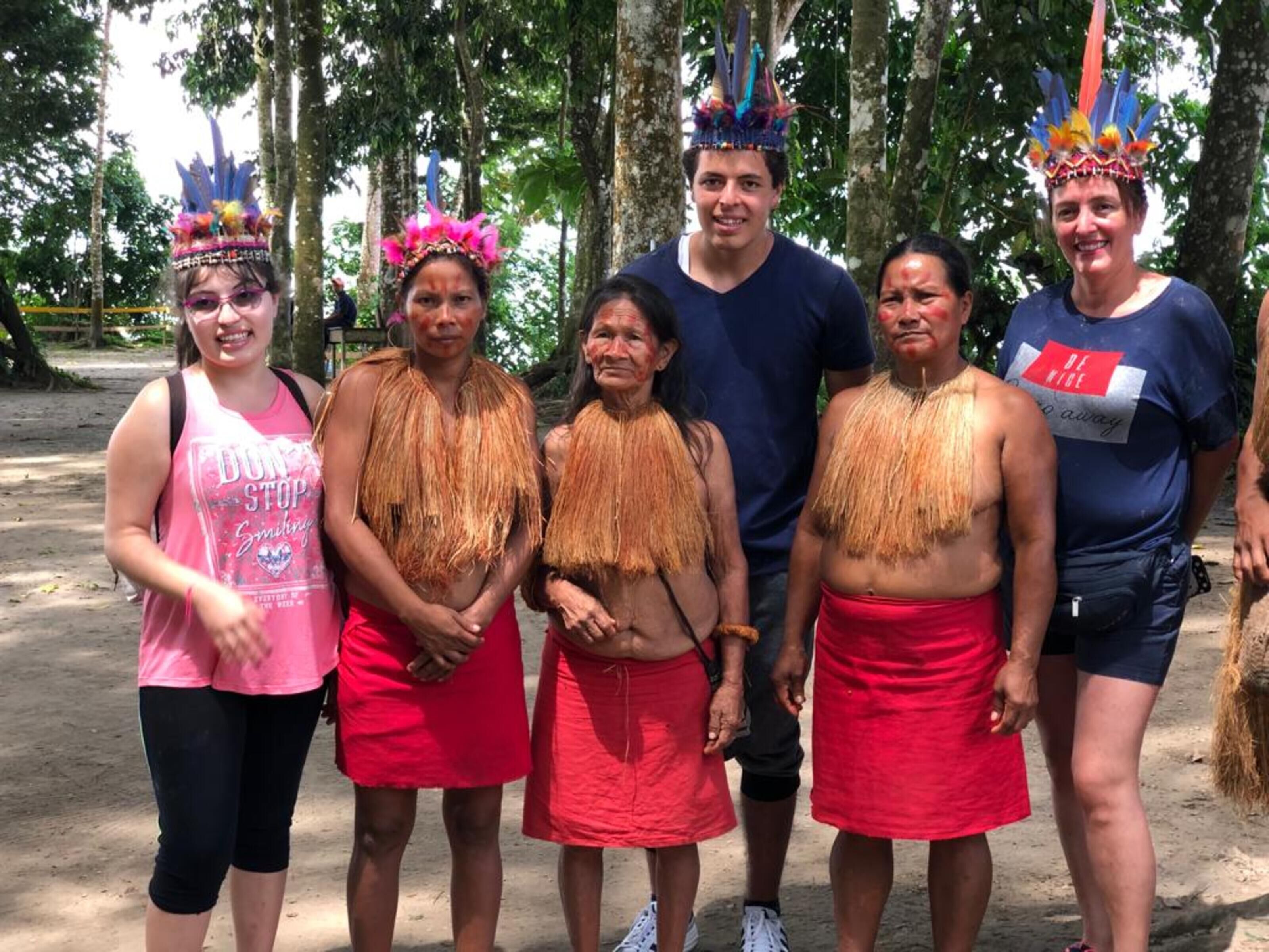 A group of people in traditional attire standing outdoors.