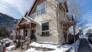 A two-story house with a porch, a staircase, and a view of a snowy mountain. - Ajax Peak Views, Townhome on Sunnyside of Historic Downtown Telluride (Telluride)