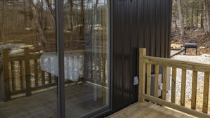 A wooden deck with a glass door leading to an outdoor area. - SUADA-Superior ADA Cabin (Park City)