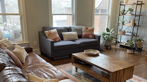 A living room with a leather sofa, a wooden coffee table, and a grey couch with patterned cushions. - Private Pool, 1st Floor Bedroom, Hershey Park, Ski Roundtop, Yellow Breeches. (Mechanicsburg)