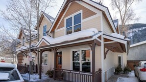 A two-story house with a covered porch and a garage. - One of Three Lovely, Sunnyside Town of Telluride Homes-Select 1, 2, or All 3! (Telluride)