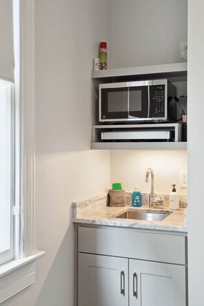 Fridge, microwave, coffee/tea maker, cookware/dishes/utensils