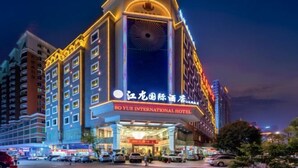 A hotel with a prominent entrance, multiple floors, and illuminated signage. - Jianglong Hotel (Dongguan Houjie Wanda Plaza) (Dongguan)