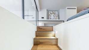 A modern staircase with wooden steps and white walls. - Le Victor Hugo, air conditioning, elevator, balcony (Nice)