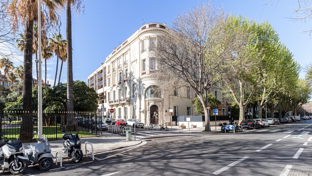 A street view with a historic building, parked scooters, and cars. - Le Victor Hugo, air conditioning, elevator, balcony (Nice)