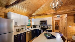 A modern kitchen with white cabinets, stainless steel appliances, and a central island. - Modern Cabin w/ Trail to Waterfall/Cave/Cliff (FV) (Rockbridge)
