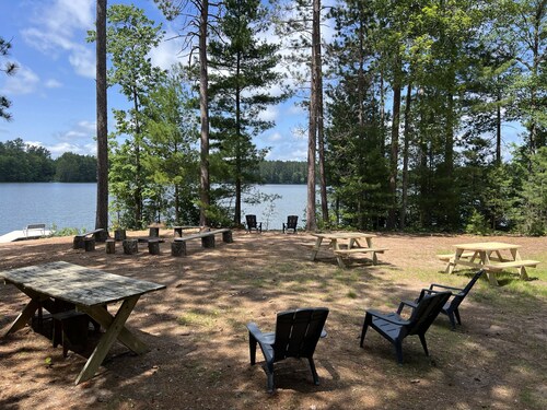 New!  Sleeps 15 Level lawn to lake.  Sandy beach.  Two docks. Great fishing.