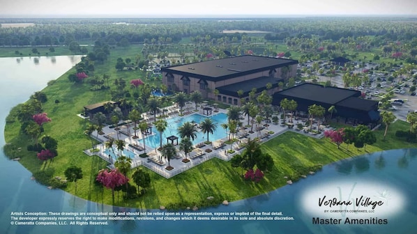 Een resort met een groot zwembad, meerdere gebouwen en veel groen eromheen.