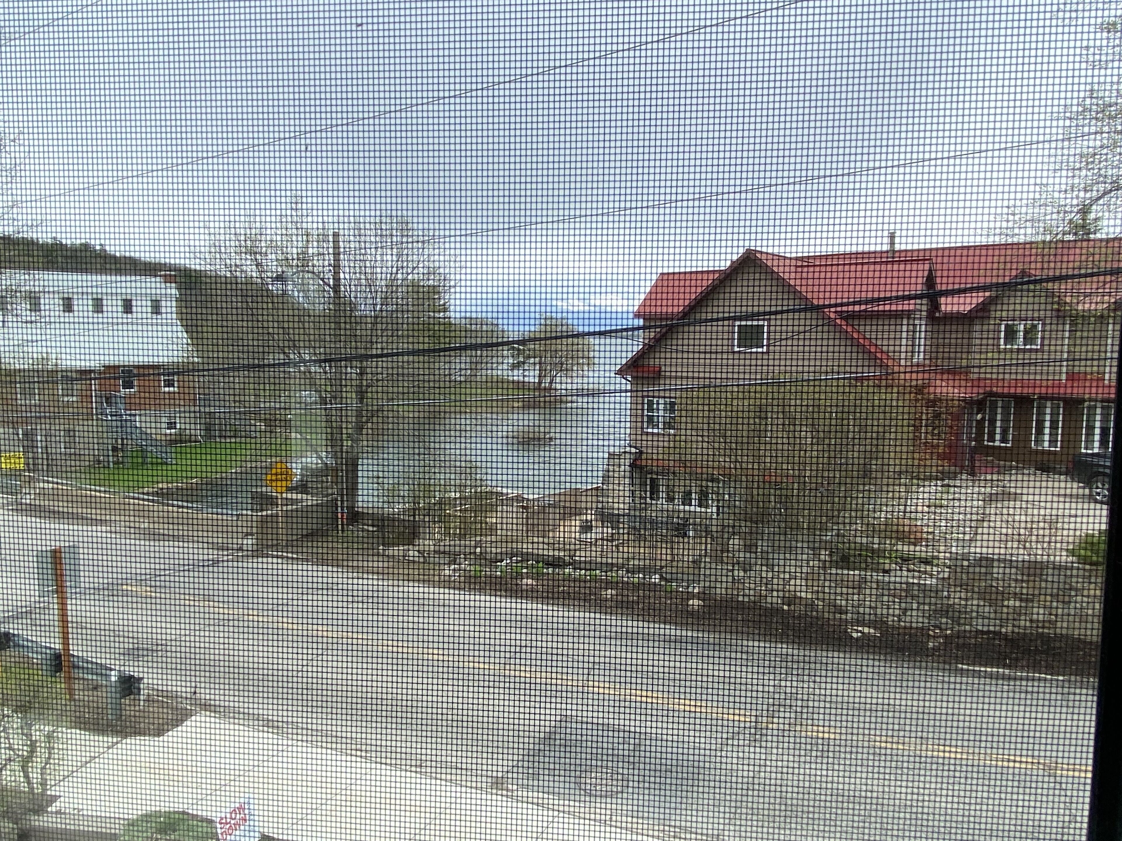 A residential area with houses, a road, and a fence.