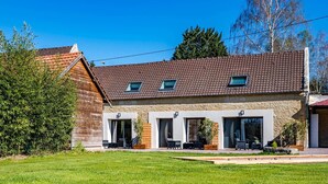 A two-story building with a tiled roof, large windows, and a grassy front yard. - La Grange du Noé: L'Odon (Caen)