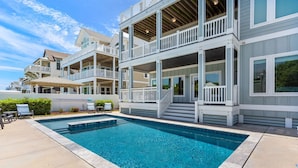 A multi-story residential building with a swimming pool. - Coastal LunaSea: Oceanfront, Pool, Elevator OBX (Corolla)