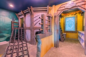 A themed play area with a climbing structure and a display of a map.