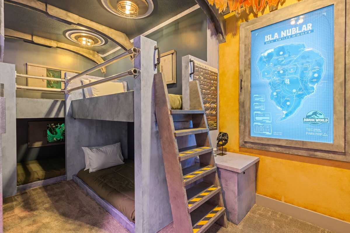 A bunk bed room with a map of Isla Nublar, a Jurassic World theme.