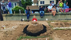 A sand sculpture of a beach with the words "SHORT BEACH" written on it.