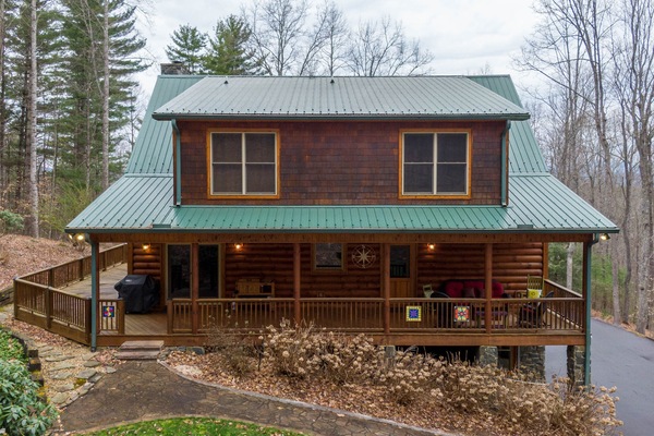 Classic log construction, a sweeping covered porch, and wooded seclusion waiting for your crew at The Forge in Blowing Rock.