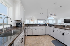 Enjoy cooking in this well-equipped kitchen with a large island, sink, and ample counter space.