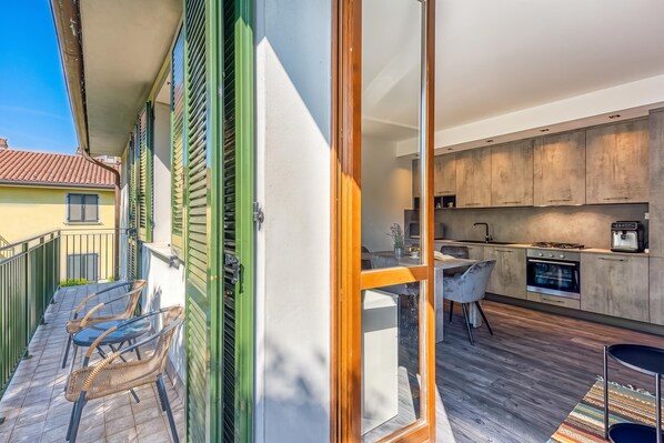 A modern kitchen with a built-in oven and a dining area with a table and chairs.