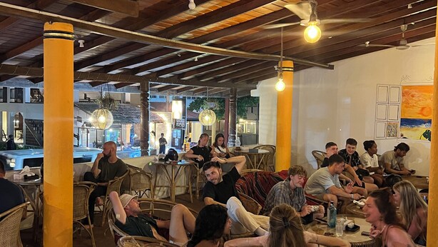 A restaurant with wicker furniture, wooden beams, and hanging light fixtures. - Hummus Hotel Hikkaduwa  (Hikkaduwa)