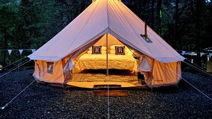A tent with a triangular roof, a bed inside, and a letter 'R' on the bed. - Radio Ranch (Burnt Ranch)