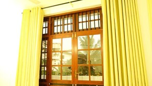 A wooden door with glass panels and a metal handle. - Cottage 23 (Kurunegala)