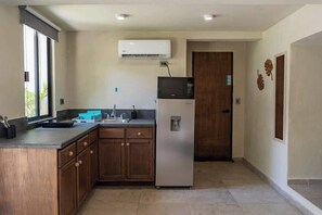 Fridge, microwave, coffee/tea maker, cookware/dishes/utensils