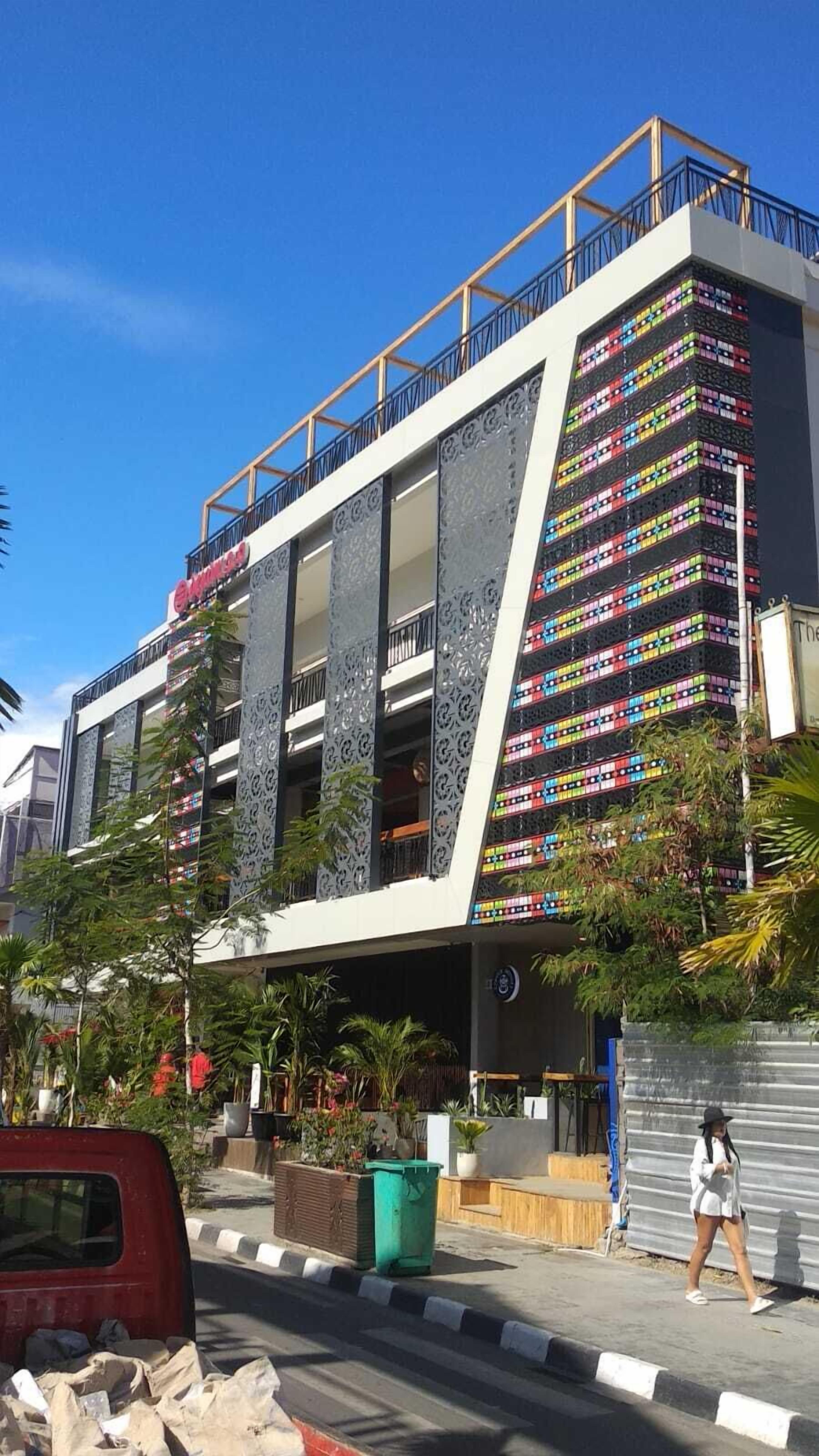 A modern building with a unique facade featuring colorful containers.
