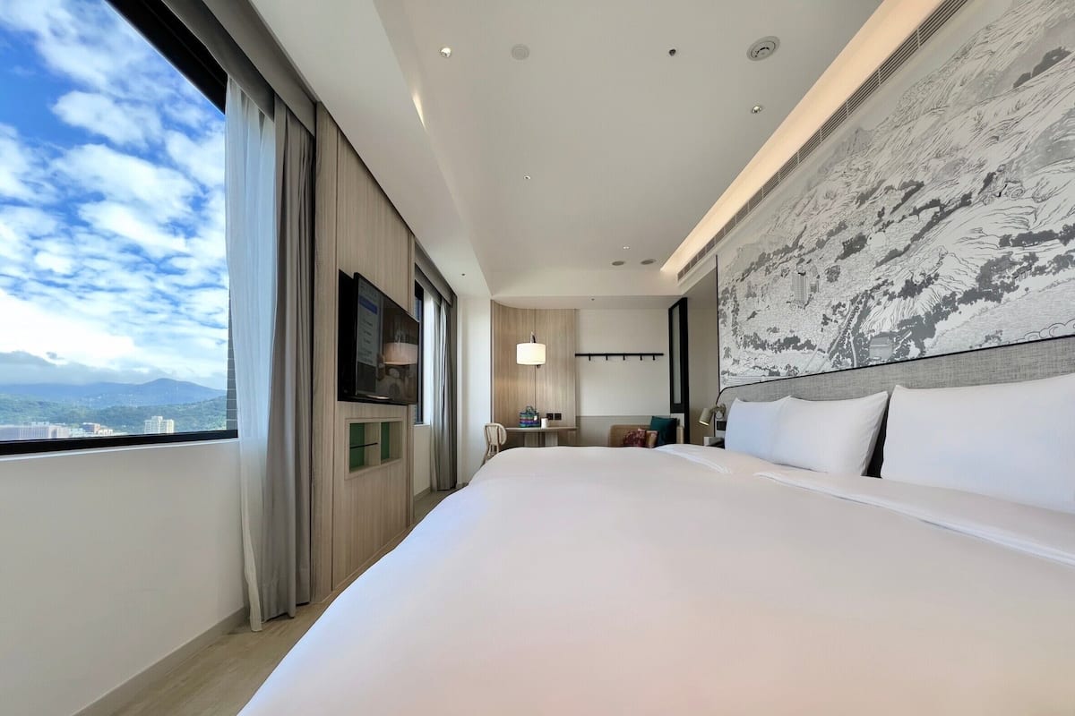 Habitación cuádruple familiar | Ropa de cama de alta calidad, edredón, minibar y cortinas blackout