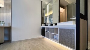 A modern bathroom with a wooden floor, a white vanity with a mirror, and a glass partition. - Jiantan Boutech Hotel (Taipei)