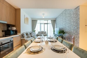A modern kitchen with a dining area set for a meal.