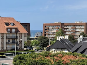 Un edificio residencial con varios balcones, vistas despejadas al mar y una mezcla de estilos arquitectónicos modernos y tradicionales.