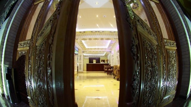 A grand lobby with ornate gold detailing, a reception desk, and a spacious seating area. - Hotel Sultan Boutique (Samarkand)