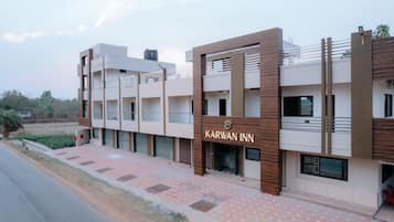 A modern building with the sign "Karwan Inn" indicating a hotel.
