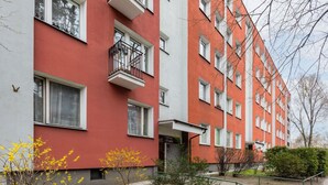A multi-story residential building with balconies and a small garden area. - Bright Studio with Balcony | Tranquil Zoliborz (Warszawa)