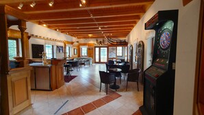 A spacious indoor area with a dartboard, a coffee machine, and a bar area. - Hotel Seiffener Hof (Seiffen)