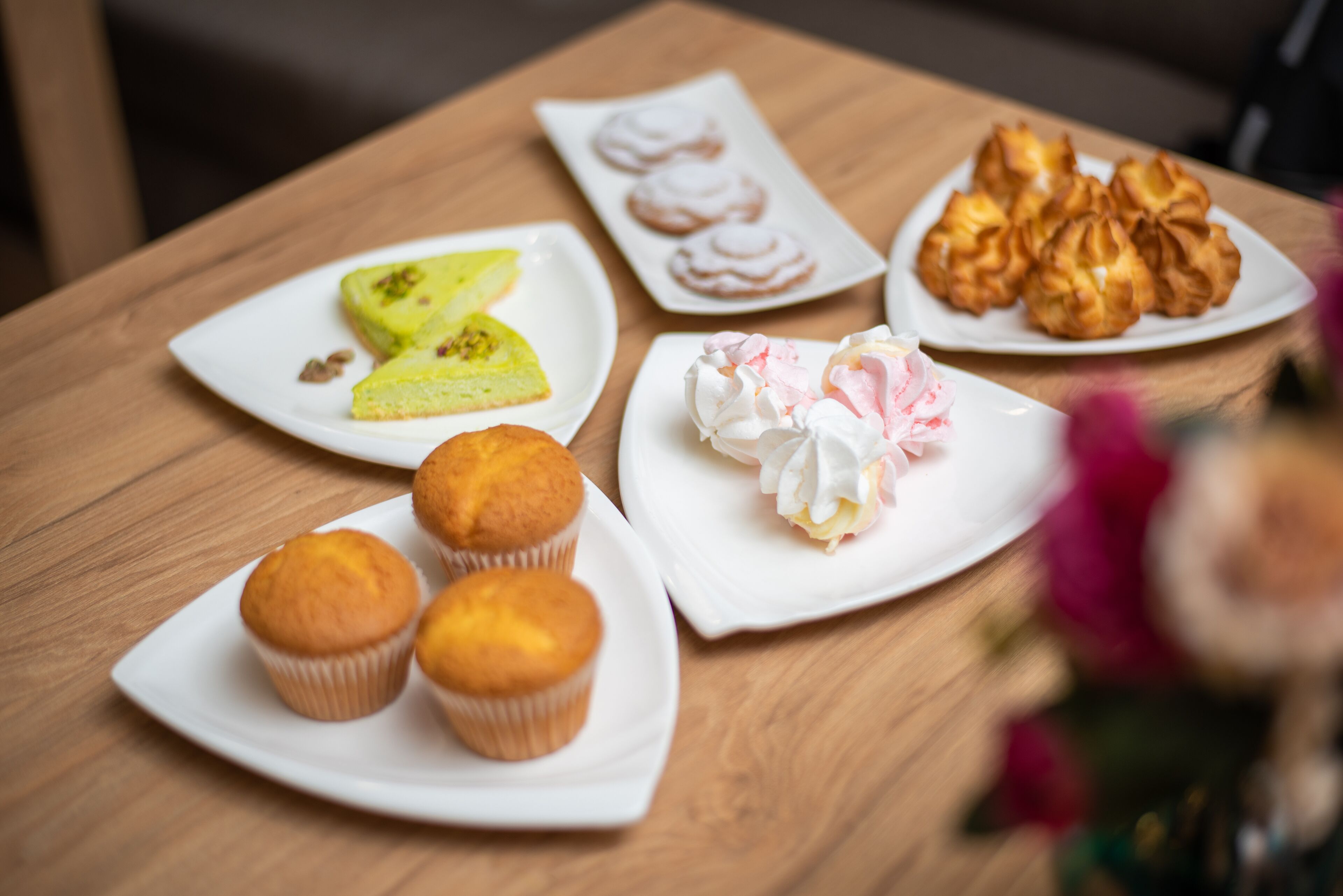 A table with various pastries and a slice of cake.