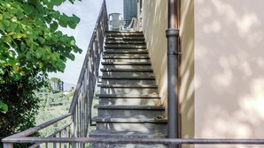 A staircase leading up to a building with a metal railing and a view of the surrounding landscape. - Rossello - Apartment with pool (Cantagrillo)