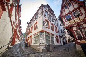 A traditional European building with a sign indicating a restaurant.