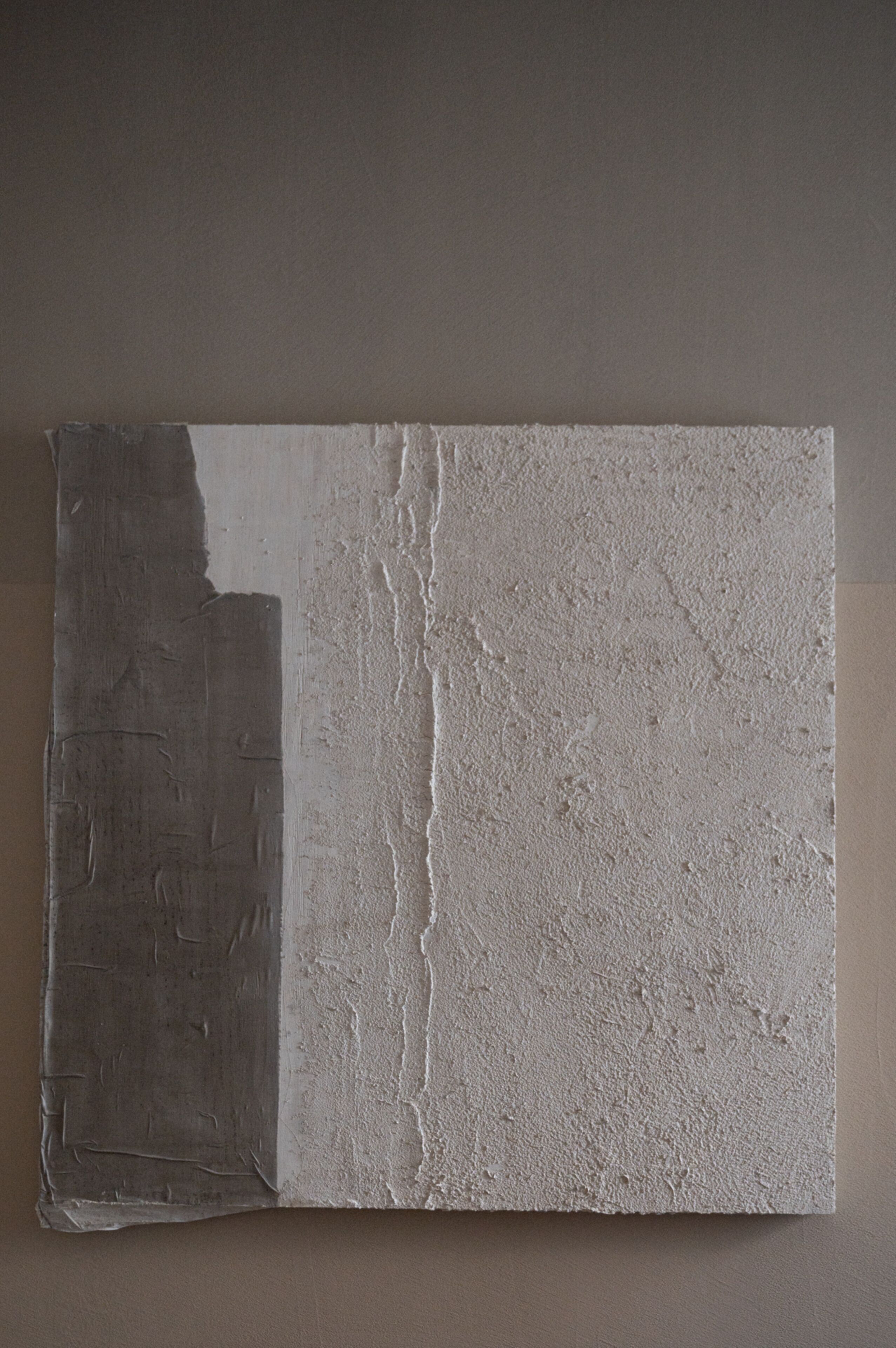 A textured wall with a rough, uneven surface.