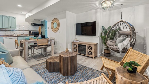 A modern living space with a kitchen, dining area, and seating area.