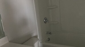 A bathroom with a toilet, a sink, and a shower. - Town house for rent (Lilburn)