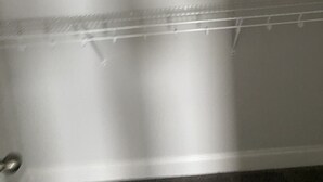 A close-up of a metal rack with horizontal bars, likely part of a storage or display unit. - Town house for rent (Lilburn)