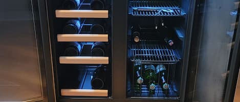 A wine refrigerator with multiple shelves, a digital display, and a control panel.