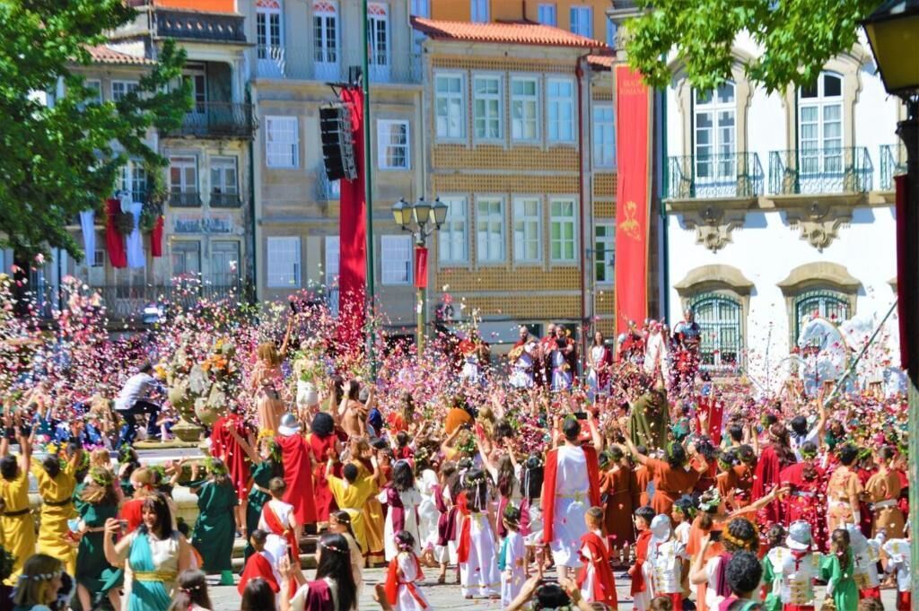 A crowded outdoor event with people in colorful traditional attire.