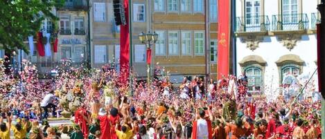 A crowded outdoor event with people in colorful traditional attire.