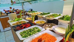 A buffet with various food items and serving utensils.