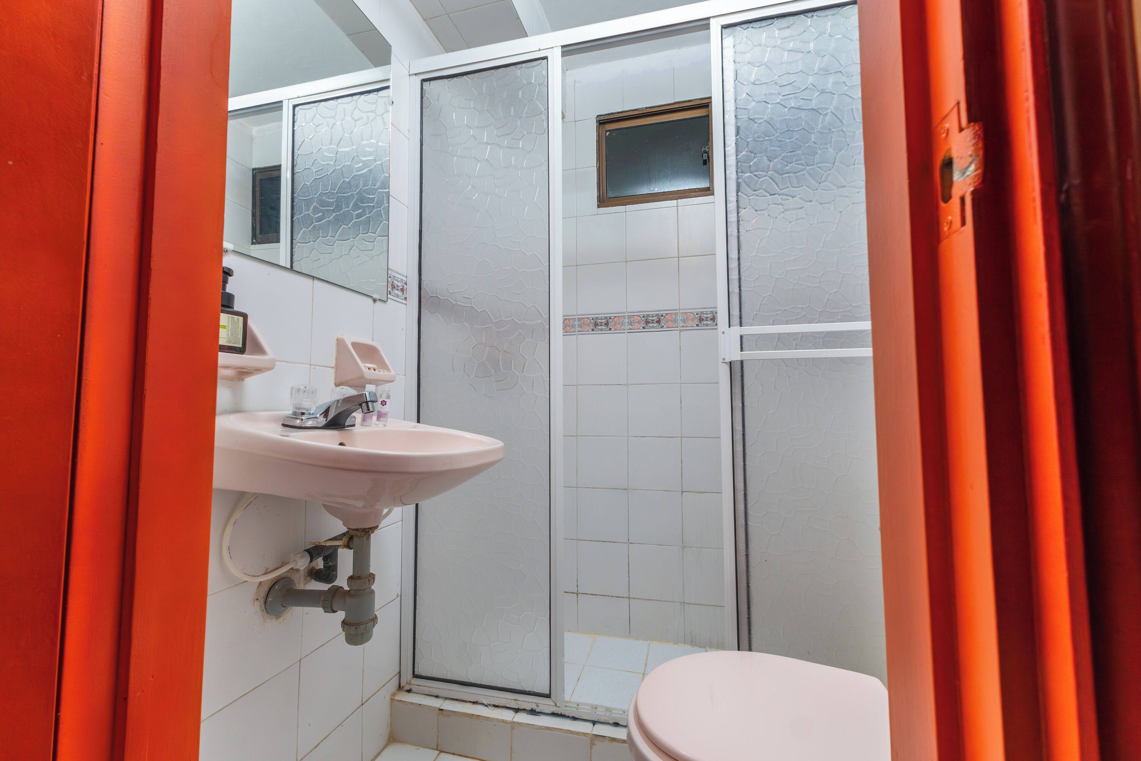 A bathroom with a sink, toilet, and shower.