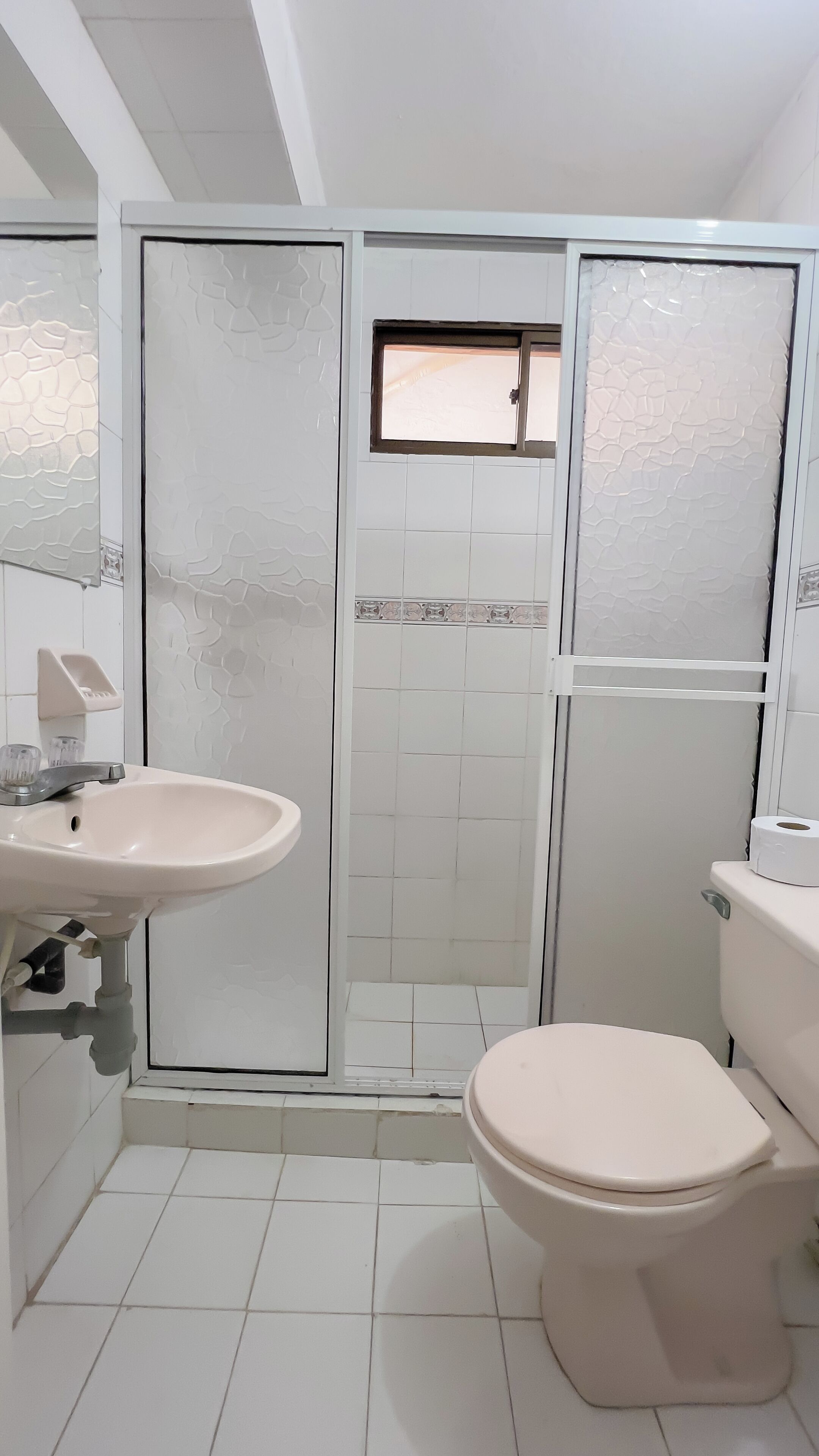 Un bagno con lavandino, WC e cabina doccia.