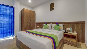 Desk, iron/ironing board, bed sheets